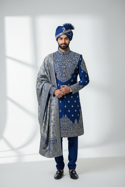 Pakistani groom wearing royal blue and silver embroidered wedding suit